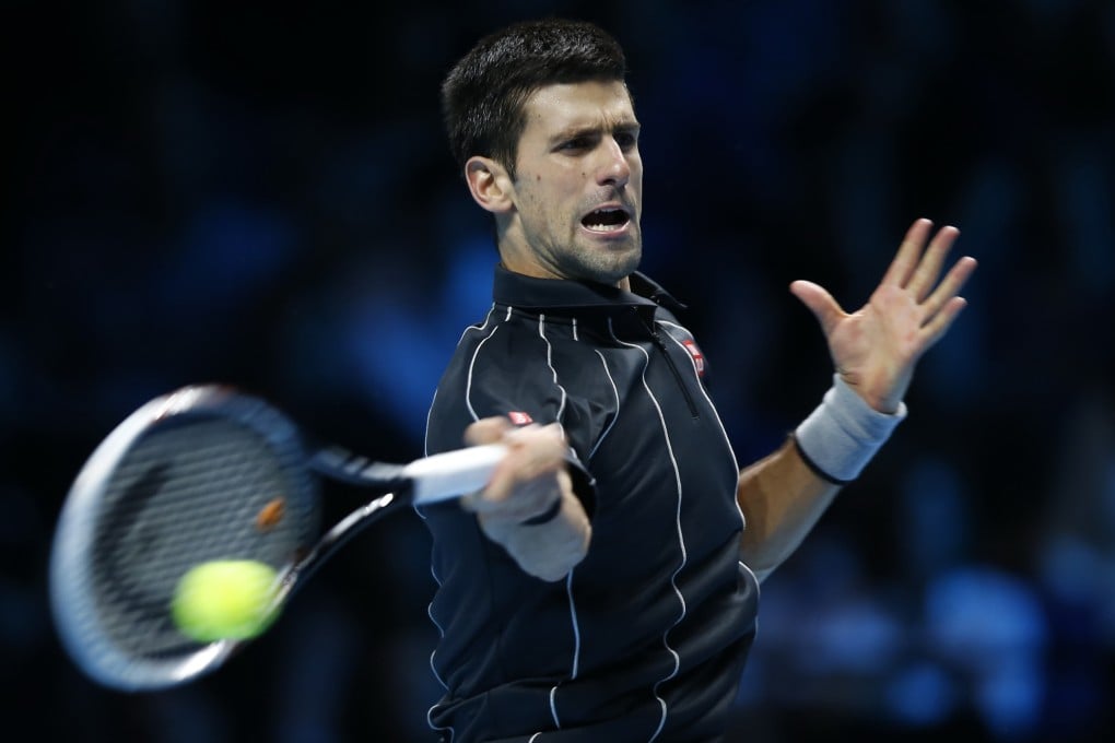 Novak Djokovic hits a return against Juan Martin del Potro. Photo: Xinhua