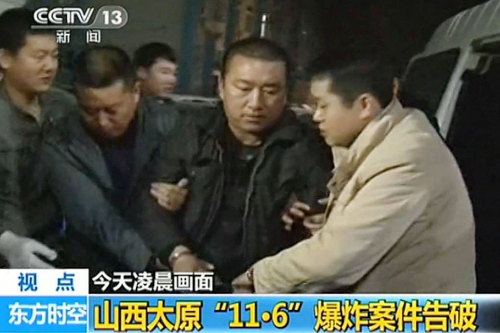 State television shows police escorting Feng Zhijun during his detention yesterday. Photo: SCMP Pictures