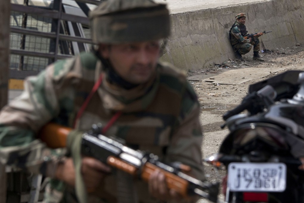 Indian army soldiers take position during a shooting near a military convoy on the outskirts of Srinagar, India. India is bracing for more militancy in the battle-scarred region of Kashmir. Photo: AP