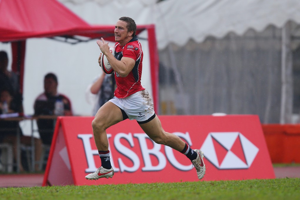 Tom McQueen heads for the try line in Hong Kong's 10-0 win over China on the first day of the Singapore Sevens. Photo: SCMP Pictures