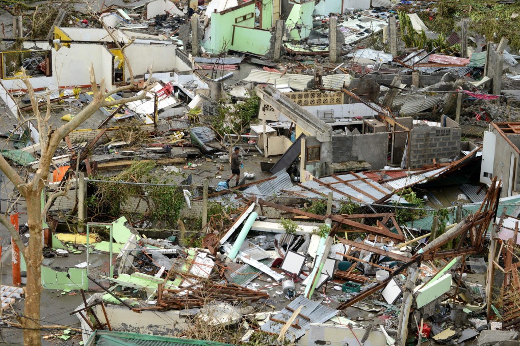 A man surveys the remnants of homes and buildings razed by Super Typhoon Haiyan, one of the strongest typhoons on record. Photo: AFP