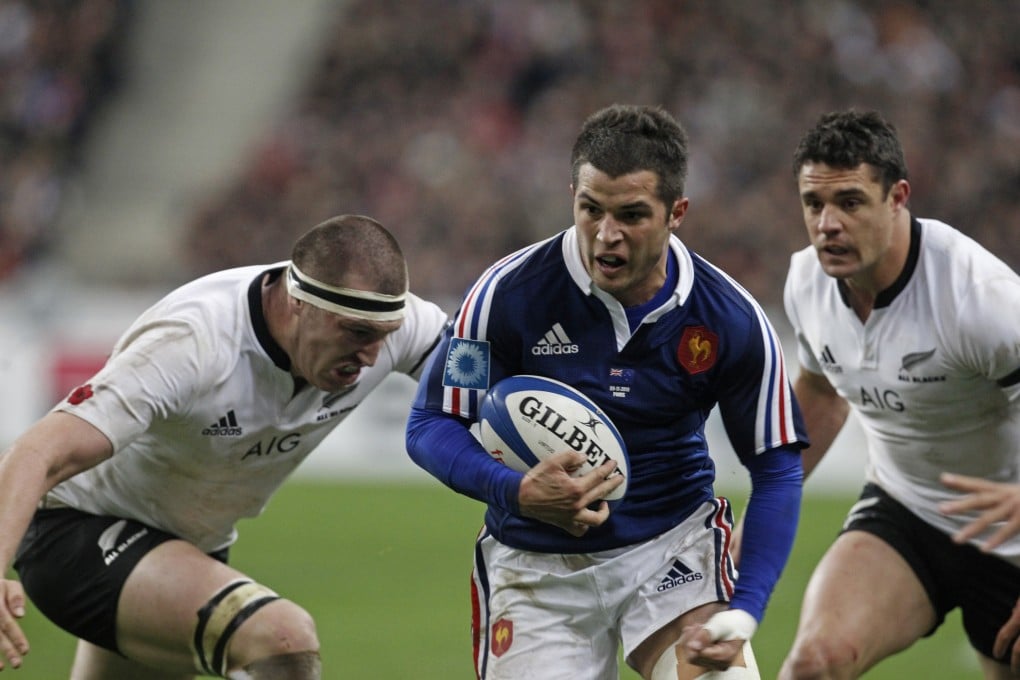 France's Brice Dulin runs with the ball as the All Blacks Brodie Retallikck and Dan Carter try to stop him at the Stade de France stadium in Saint Denis, outside Paris, on Saturday. Photo: AP