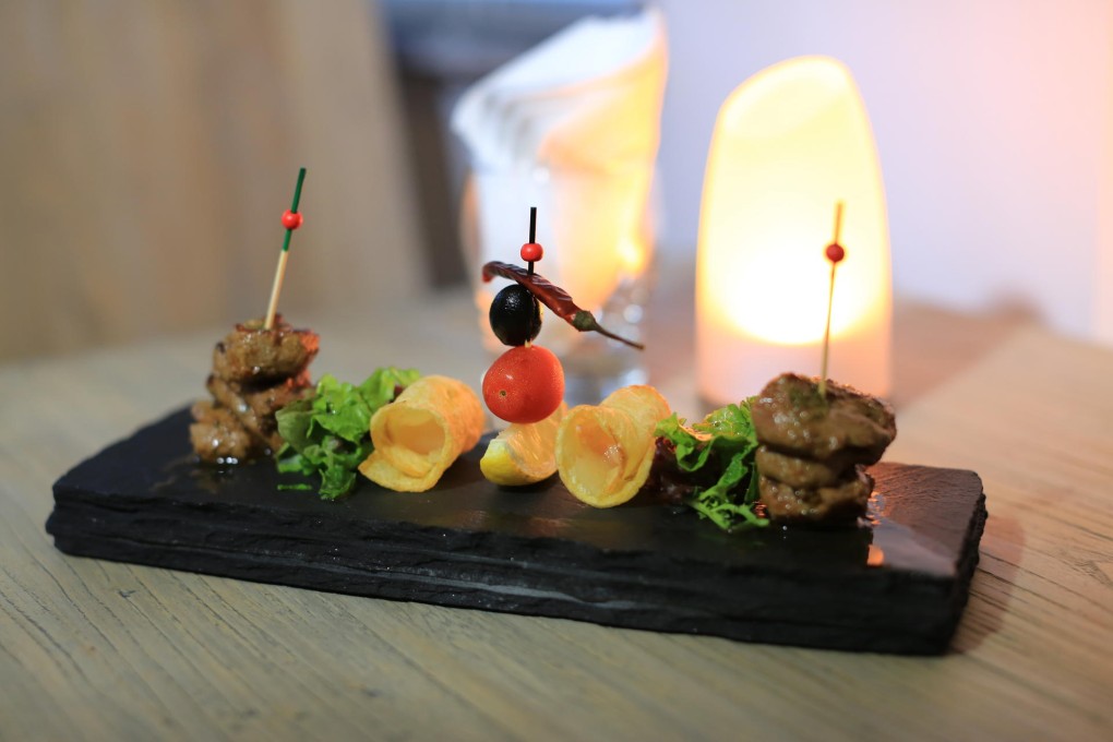 Lamb skewers with potato crunch and sweet onion confit at Casa de Tapas in Taipa village