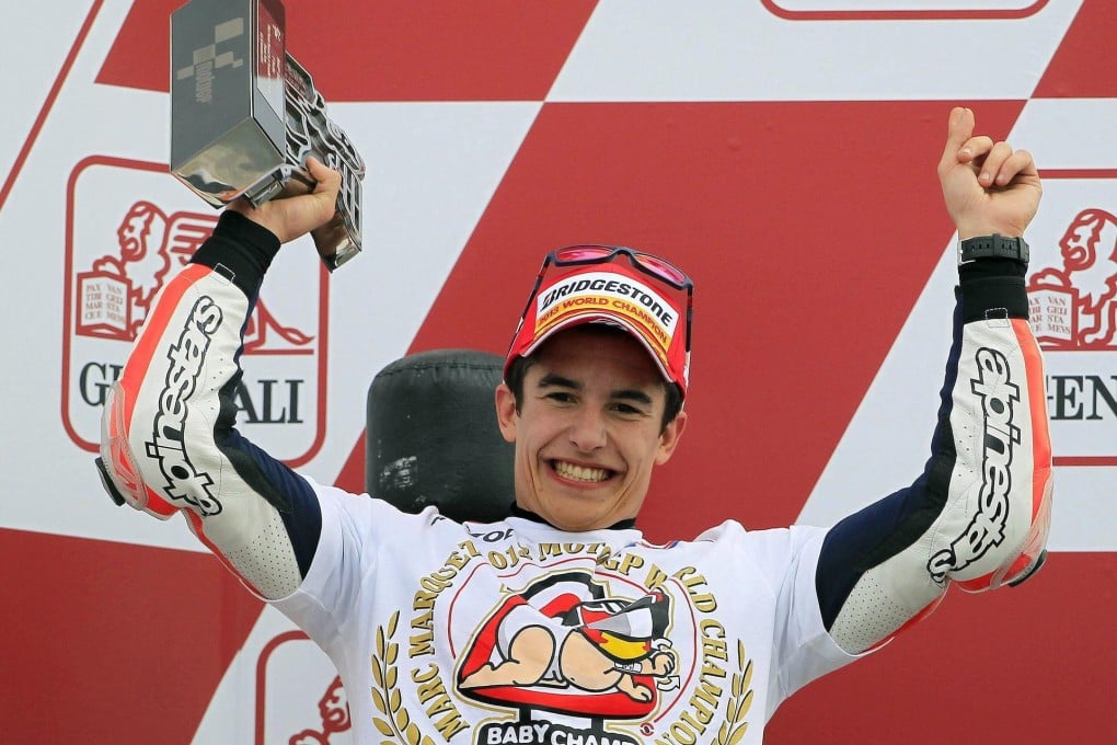 Honda's Marc Marquez celebrates his third position in the Valencia Grand Prix that earned him the world title. Photo: EPA
