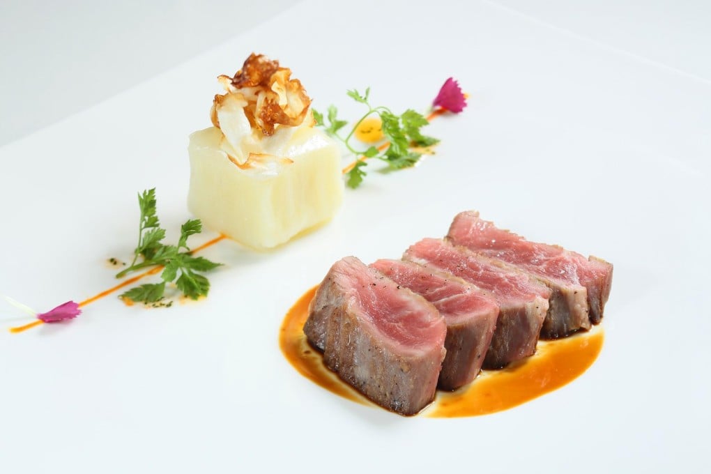 Zurriola's grilled Iberian pluma with potato cabbage cake and port wine sauce