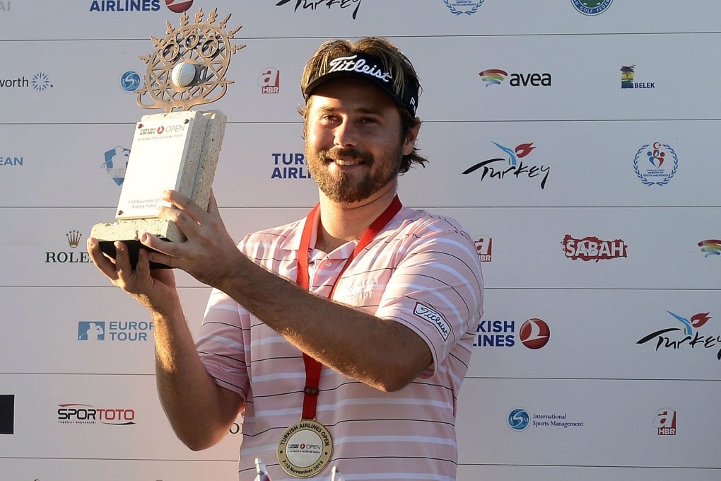 Victor Dubuisson of France poses with his trophy after winning the 2013 Turkish Airlines Open. Photo: AFP
