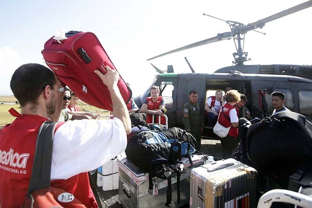 Aid workers and relief supplies are being poured into eastern Philippine provinces hit by Typhoon Haiyan, which aid agencies and officials estimate has left thousands dead and staggering destruction in its wake. Photo: EPA