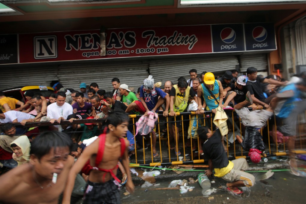 Chaotic scenes in the devastated city of Tacloban in Leyte province, where the death toll may reach 10,000. Law and order has broken down in parts of the Philippines hit by typhoon Haiyan. Photo: EPA