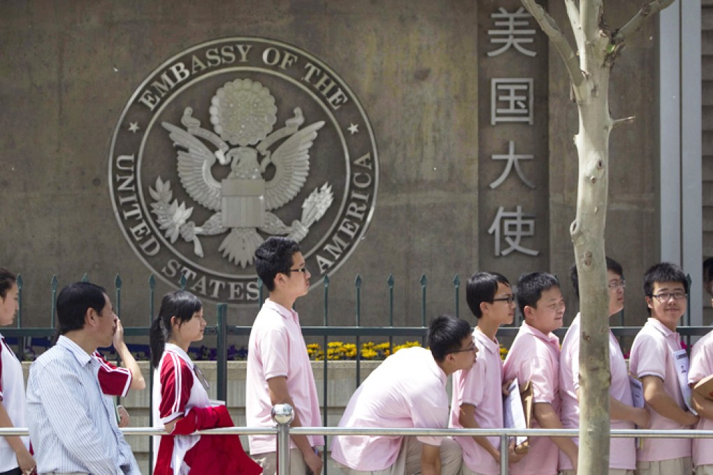 Students line up outside the American embassy in Beijing for interviews as part of a visa application process. Photo: AP