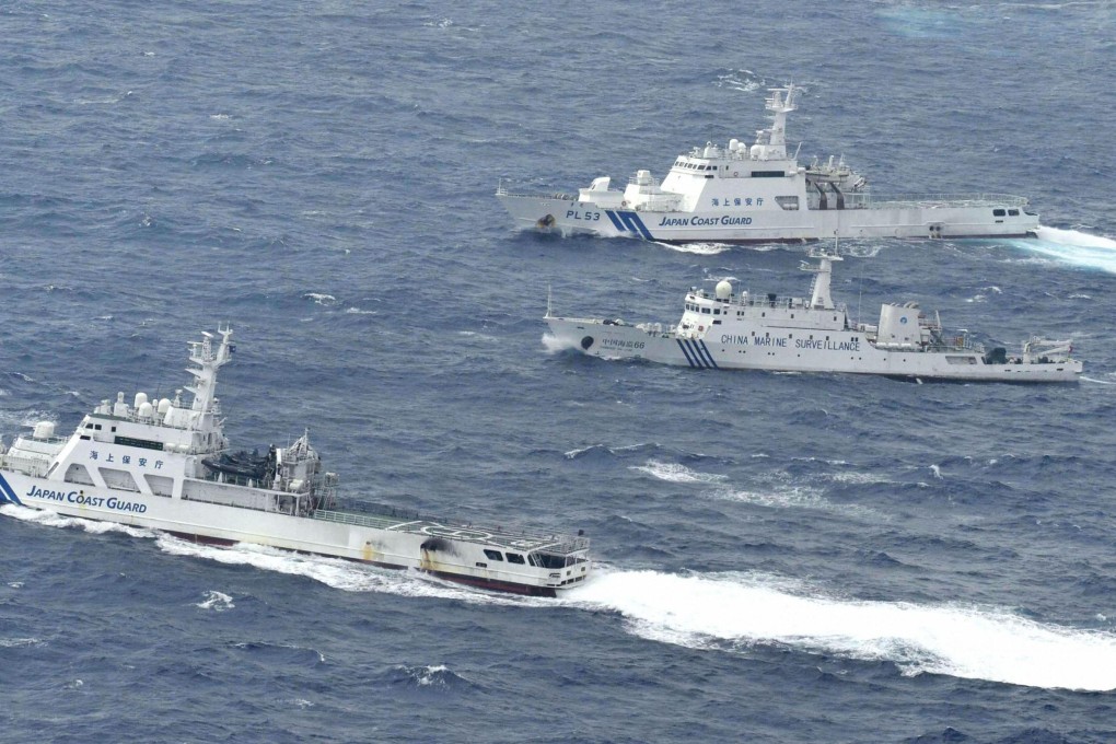 A Chinese marine surveillance ship (centre) cruises next to Japan Coast Guard patrol ships in the East China Sea. Photo: Reuters