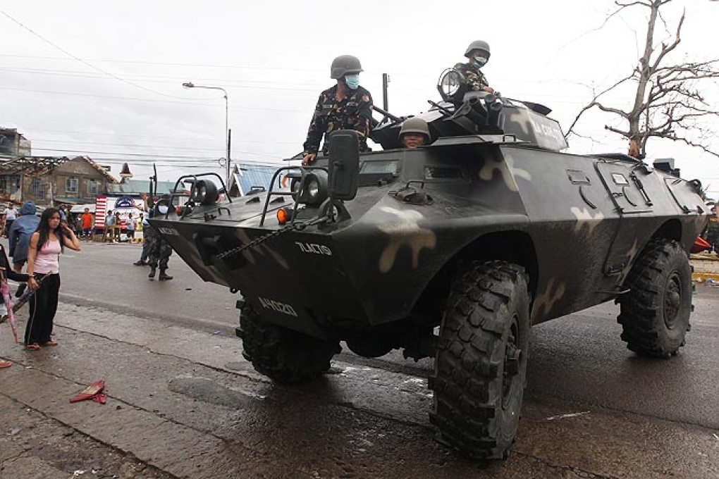 A tank manned by Filipino soldiers is seen on patrol at a street in the super typhoon devastated city of Tacloban, Leyte province, Philippines, on Monday. Photo: EPA