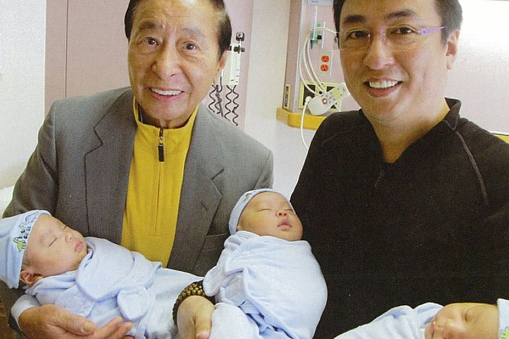Lee Shau-kee and his elder son Peter Lee Ka-kit took a picture with their new-born babies via surrogate. Photo: SCMP