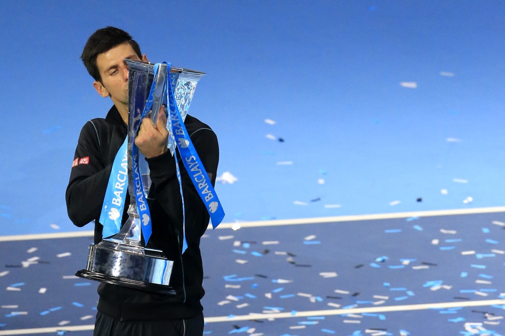Novak Djokovic kisses the trophy after beating Rafael Nadal in the title match of the ATP World Tour Finals in London. Photo: Xinhua