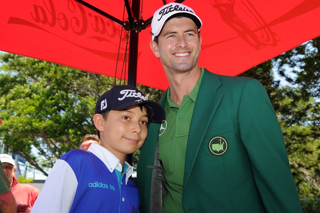 Australian golfer Adam Scott, who loves to wear the Augusta "green jacket", poses with a fan. Photo: EPA