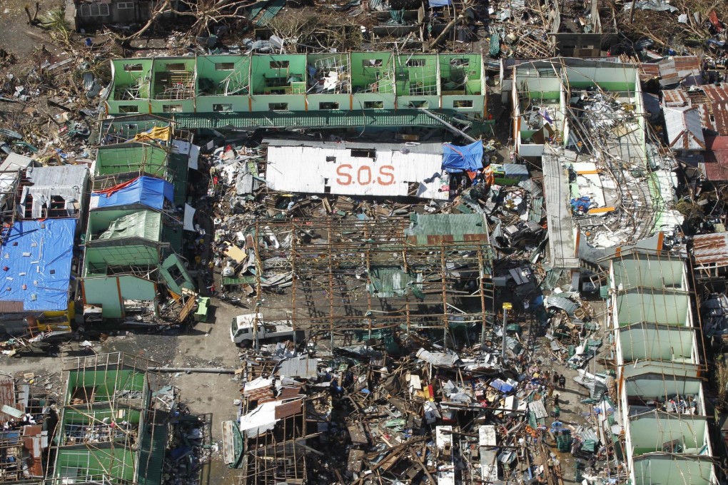 Signs calling for help amid the destruction caused by Super Typhoon Haiyan in the coastal town of Tanawan yesterday. Photo: AP