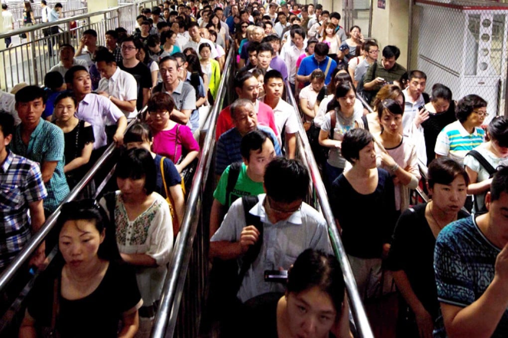 Long queues form at a Beijing subway station during the morning rush hour, where European-made ticket machines can't cope with commuters in a hurry. Photo: AFP