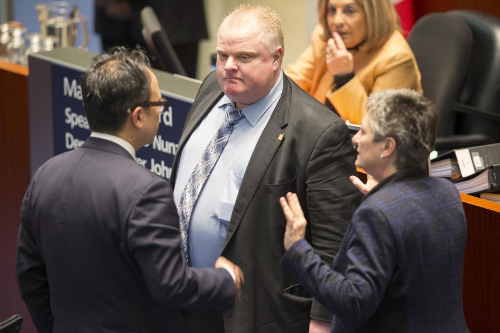 Toronto Mayor Rob Ford is confronted by councillors after the meeting at City Hall. Photo: Reuters