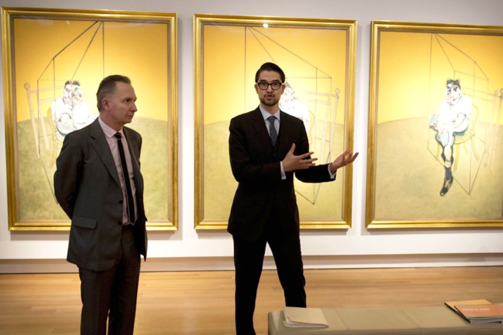 Christie's auctioneers speak about Francis Bacon's "Three Studies of Lucian Freud" in New York. Photo: AFP