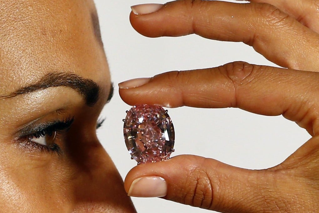 A model gets a close-up of the eye-catching Pink Star, which sold for a record price at an auction in Geneva after four people, including two Asians, made bids. Photo: Reuters