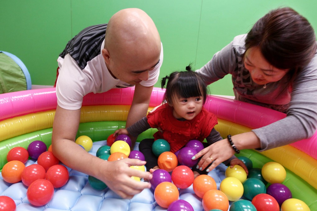 Venus Cheng, with mum Rebecca and dad Friend, plays at the Hong Kong Down Syndrome Association in Kowloon City. Photo: Jonathan Wong