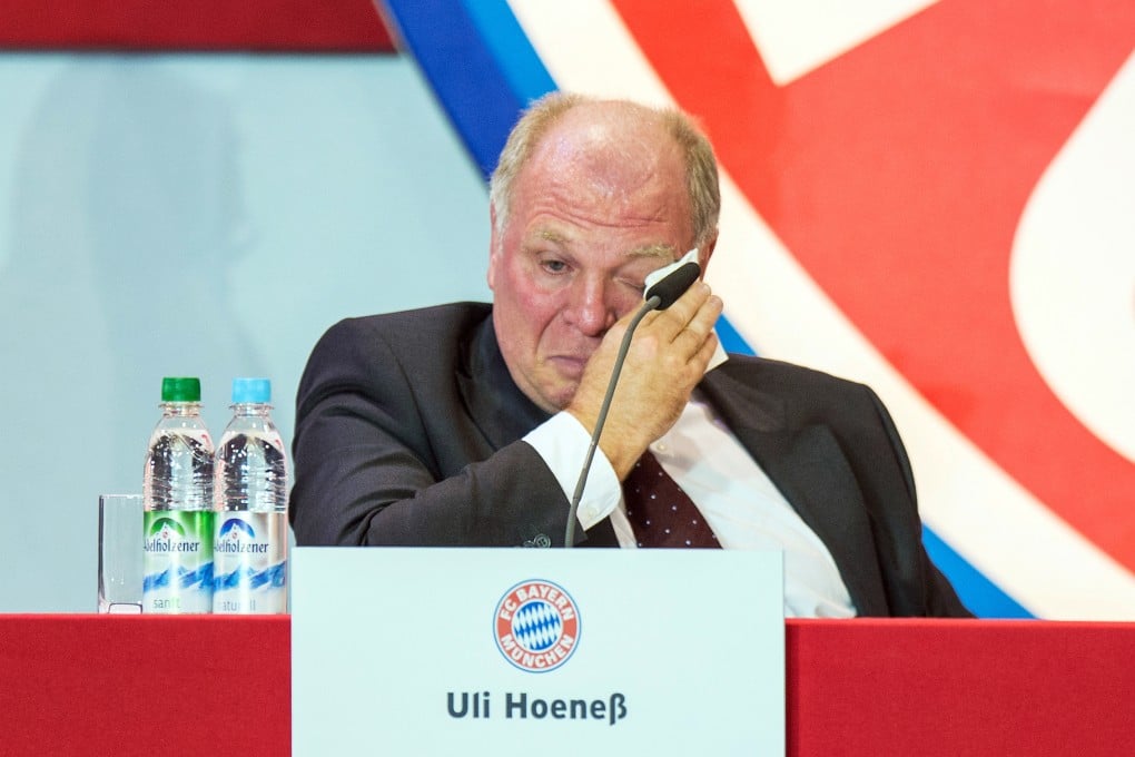 Bayern boss Uli Hoeness wipes away tears as he presents his club's financial figures. Photo: AP