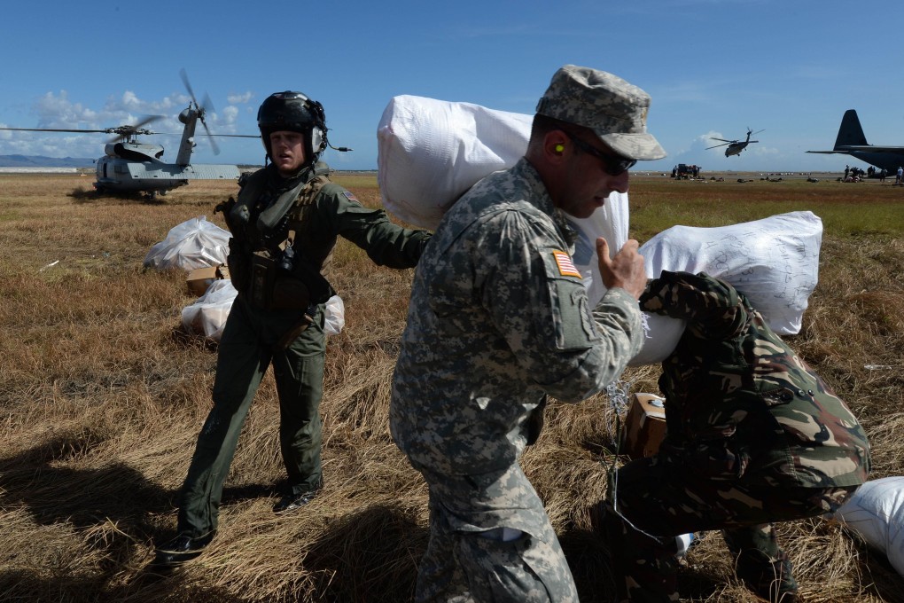 US Marines deliver relief aid at Tacloban airport. Photo: AFP