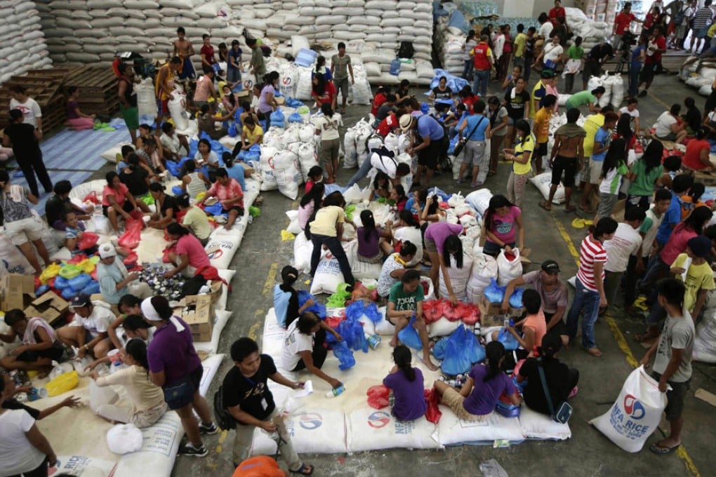 Volunteers repack food relief for typhoon victims at a warehouse. Photo: AP