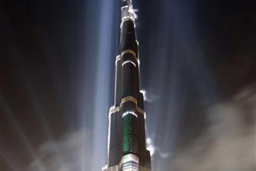 FILE - In this Jan. 4, 2010 file photo, the Burj Khalifa is illuminated during the official opening ceremony in Dubai, United Arab Emirates. According to the nonprofit Council on Tall Buildings and Urban Habitat, the Burj Khalifa is the tallest completed building in the world with the height measured at 2,717 feet. (AP Photo/Kamran Jebreil, File)
