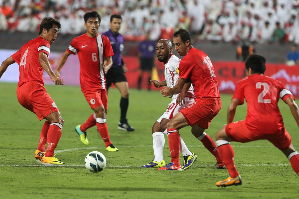 UAE's Ismaeil Matar fights for the ball against Hong Kong players during their match in Abu Dhabi. Photo: AFP