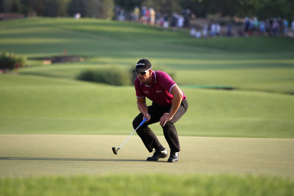 Swede Henrik Stenson lines the ball on the 18th for the last of his eight birdies he racked up. Photo: Reuters