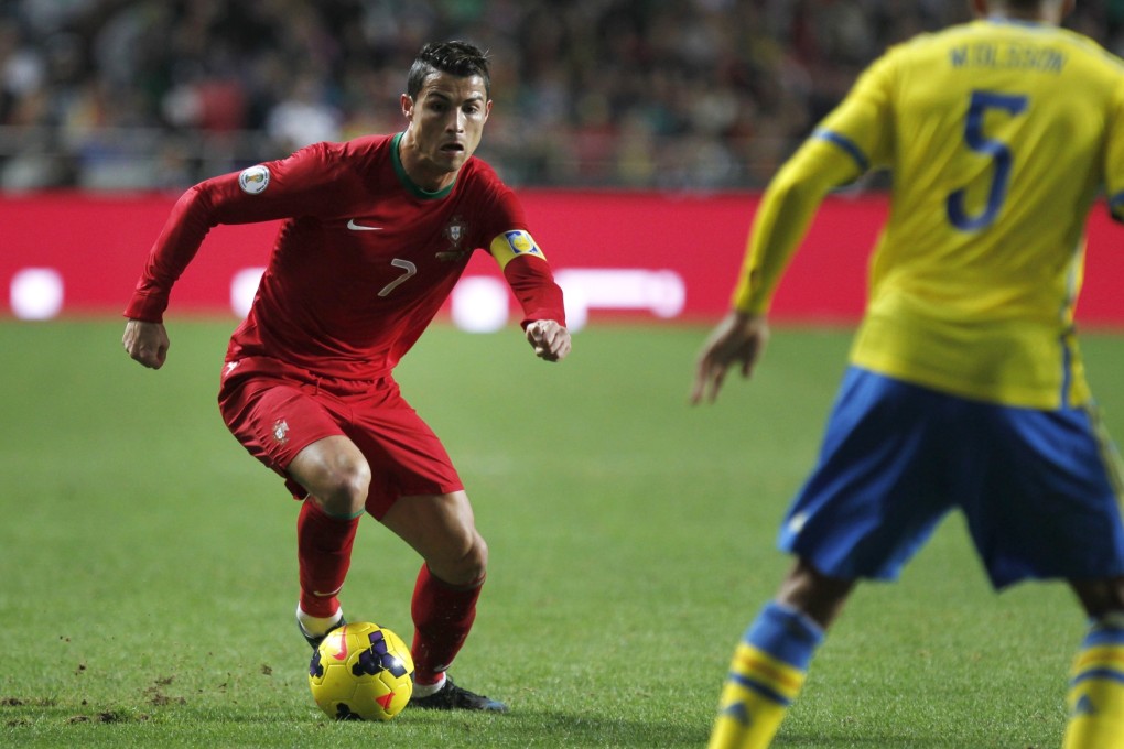 Cristiano Ronaldo runs with the ball next to Sweden's Martin Olsson, during the match between Portugal and Sweden in Lisbon. Photo: AP