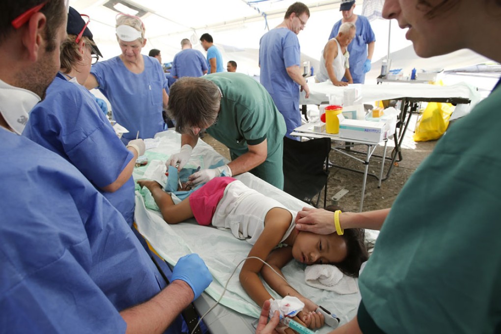 A six-year old undergoes an operation performed by visiting doctors at a make-shift hospital. Some typhoon victims could not receive adequate medical care in time. Photo: Reuters