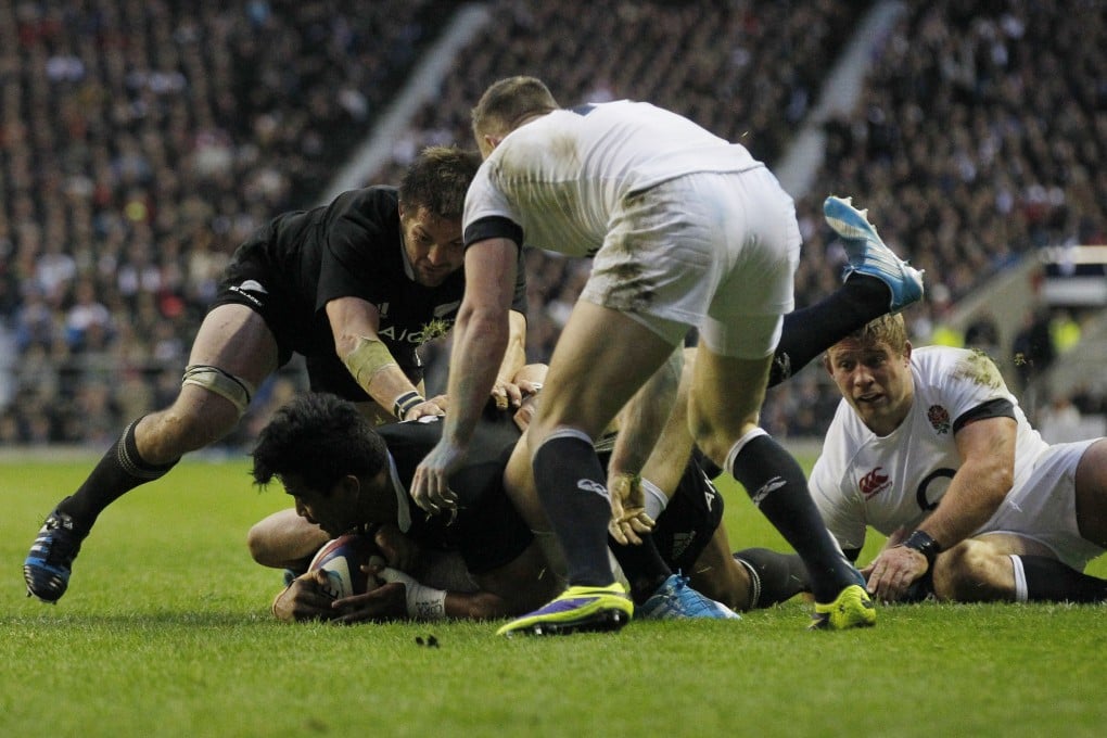 Man of the match Julian Savea (lower left) scores a try for the All Blacks against England at Twickenham. Photo: AP