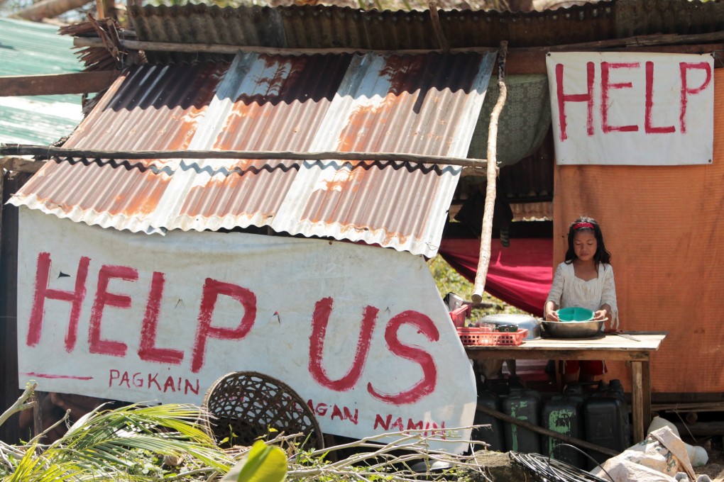 A typhoon victim in the devastated town of Balangiga, Samar province. Photo: EPA