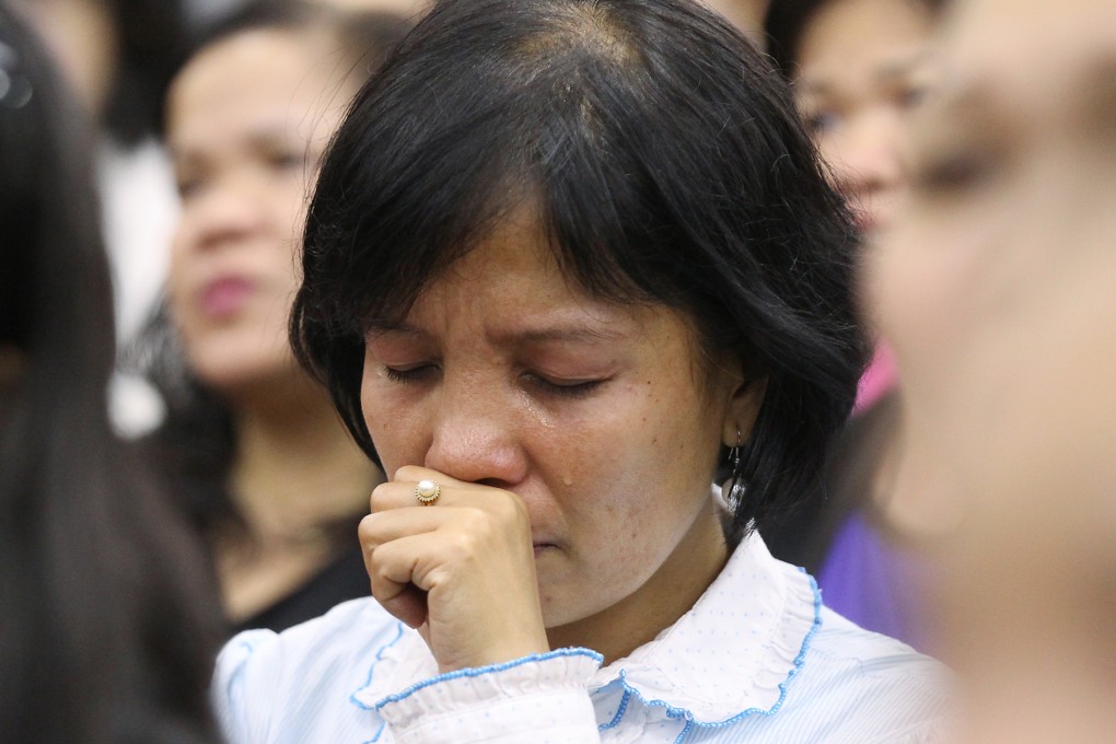 A woman at a Hong Kong mass for victims. Photo: Edward Wong