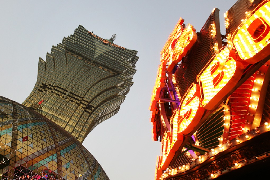 The Casino Lisboa, operated by SJM Holdings Ltd., stands illuminated at night in Macau. Photo: Felix Wong