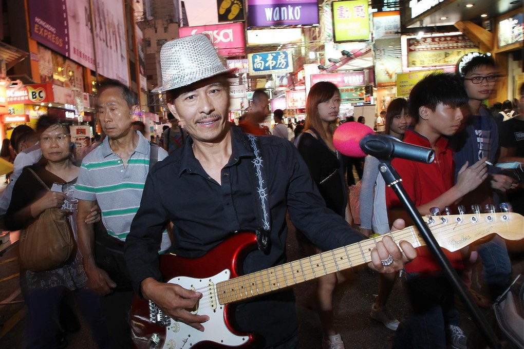 Lam Fat, lead singer of the band 3L, performs on Sai Yeung Choi Street South. Photo: Sam Tsang