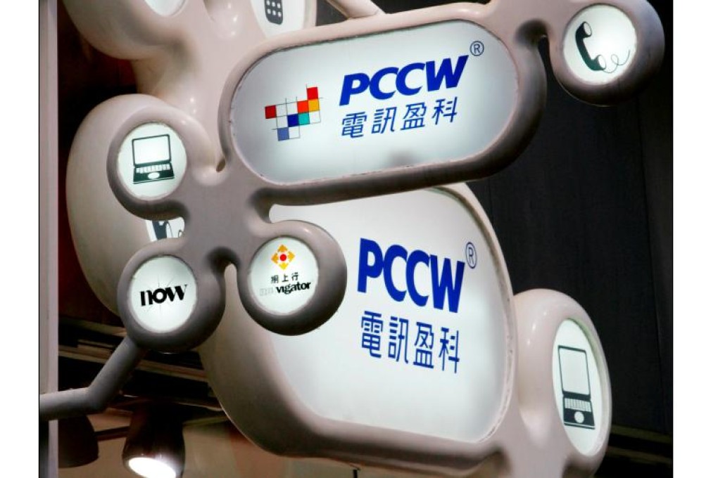 Logos of Hong Kong telecommunications and media firm PCCW are displayed at an outlet in Hong Kong. Photo: Reuters
