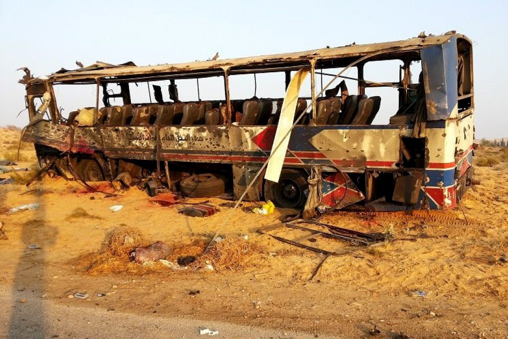 A destroyed bus after a suicide attacker hit his explosive-laden car into the bus at the road between the border town of Rafah and the coastal city of el-Arish, Egypt. Photo: AP