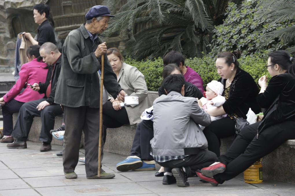 An elderly man begs for money from visitors at a park in Chongqing, Sichuan province. Photo: AP