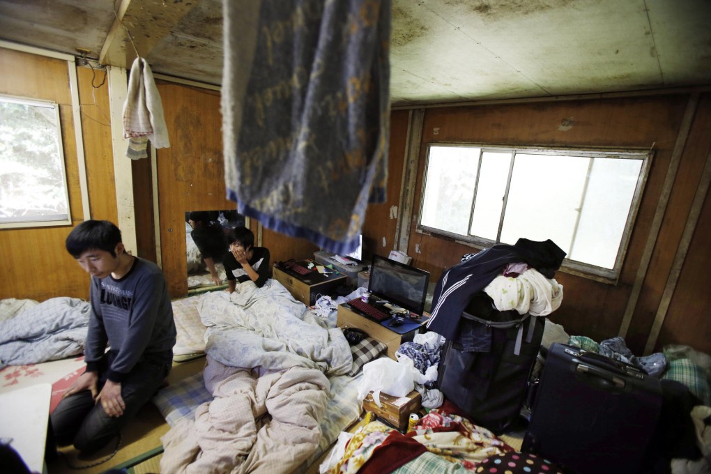 Two Chinese labourers under the Japanese internship programme in their living quarters in Hokota, Ibaraki prefecture. Photo: AP