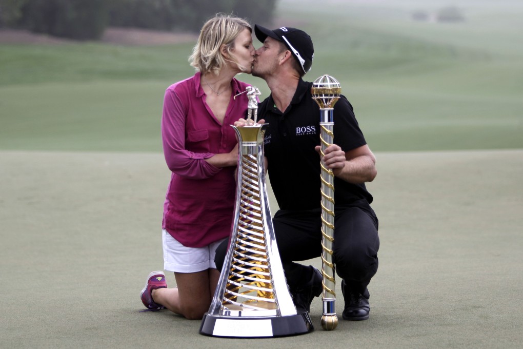 Henrik Stenson kisses his wife Emma Lofgren after he won the final round of DP World Golf Championship in Dubai. Photo: AP