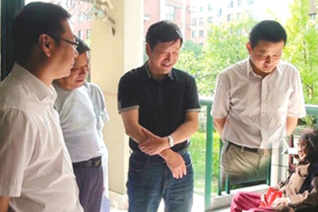 Officials in Ningguo, Anhui appear in a doctored photo showing them visiting a 103-year-old local woman. Photo: SCMP