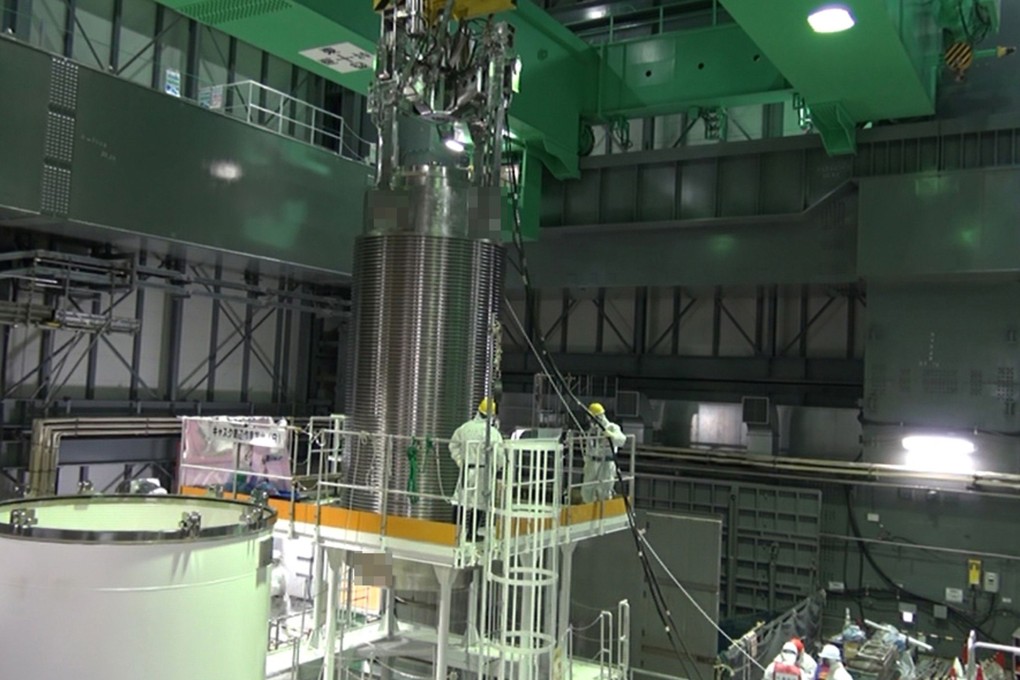 Tepco workers transfer fuel rods at Fukushima. Photo: AFP