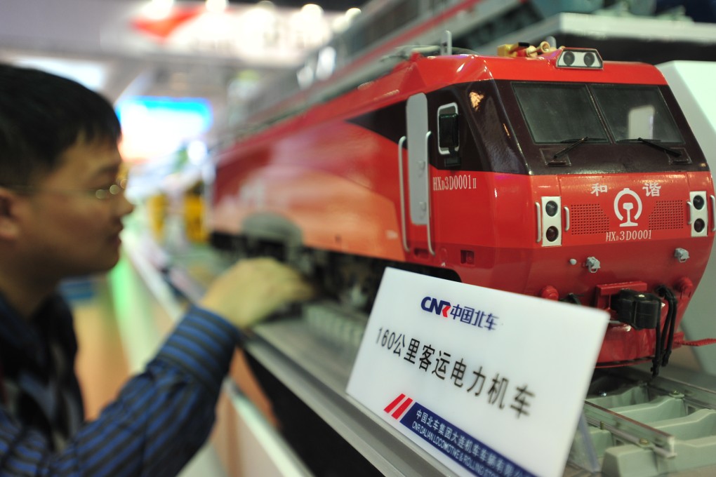 A visitor views a model of an electric locomotive made by China CNR during an exhibition in Beijing. Photo: Xinhua