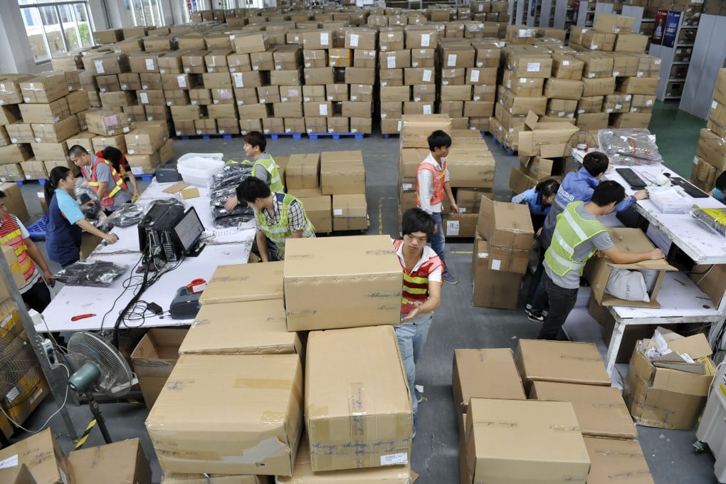 Workers check goods at the logistics center of a Tmall online shop in Guangzhou. Online retailer JD is the latest e-commerce company planning to build its own logistics network to overcome the shortcomings of the mainland's distribution sector. Photo: Xinhua