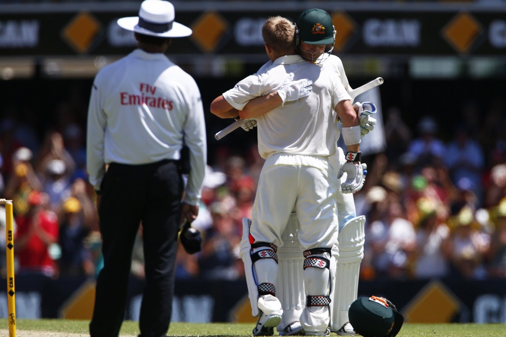 Australia’s David Warner (centre) is congratulated by captain Michael Clarke after scoring his century on the third day of the first Ashes test at the Gabba. Photo: Reuters
