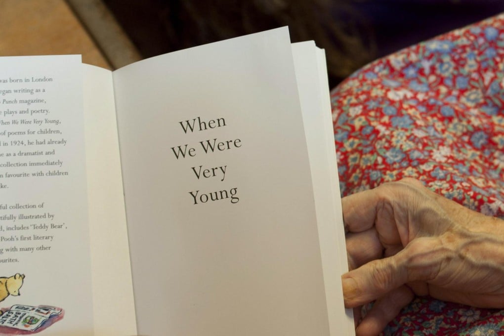 A volunteer from Kissing it Better charity reads poems to a resident of the Hylands House retirement home who has dementia. Photo: AFP