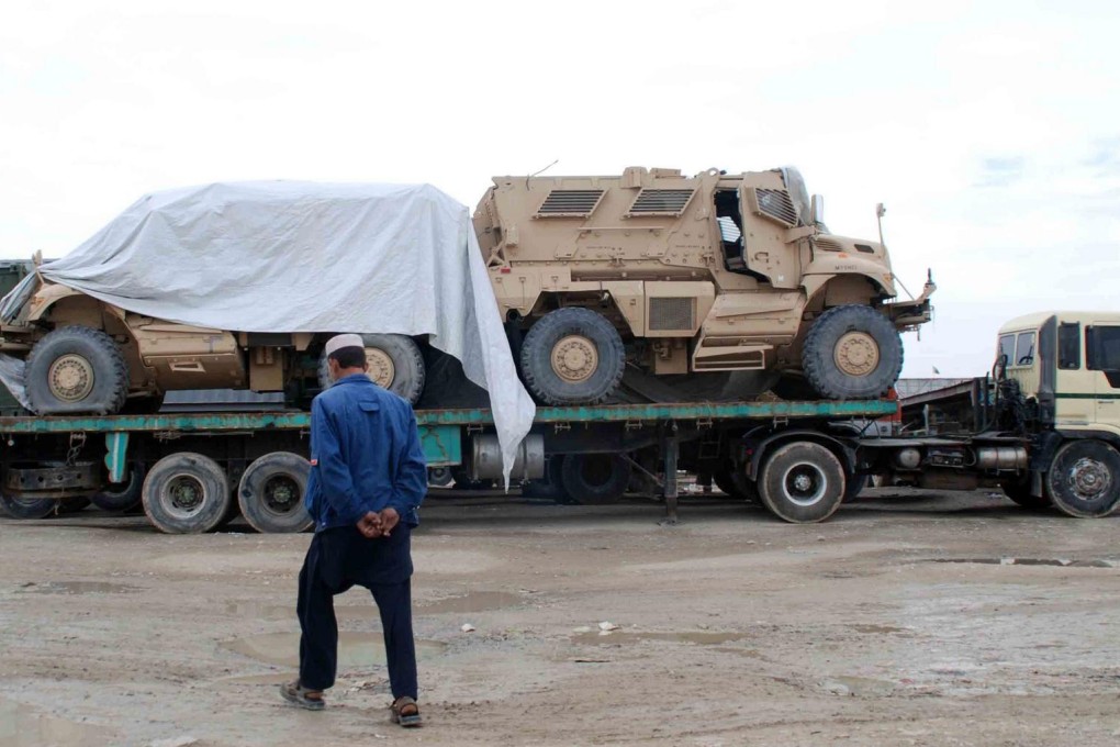 Trucks like this one, transporting Nato military vehicles across the border into Afghanistan, have been halted by protesters. Photo: EPA