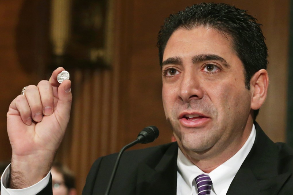 Co-founder and CEO of BitPay Anthony Gallippi holds up a nickel while speaking during Senate Banking Subcommittee hearing on virtual currency in Washington, D.C. Photo: AFP